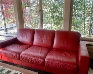 Red leather sofa with chrome feet