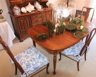 The dining room table comes with four chairs, three leaves and pads.  One of the chairs is a captain's/arm chair.  