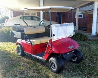 E-Z-Go battery powered golf cart.  Includes enclosure (not shown)