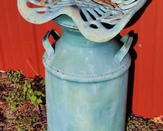A vintage John Deere 1847 tractor seat mounted on a milk can