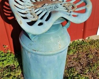 A second vintage John Deere 1847 tractor seat mounted on a milk can