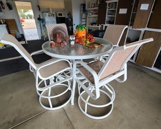 Outdoor patio high table with swivel chairs.