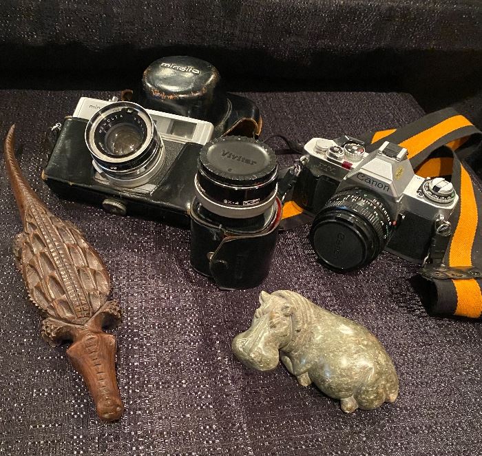 Vintage cameras, carved wood alligator and marble (house) hippo. 