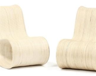 650 - Sculptural rattan lounge chairs Italian influenced hollow form with a continuous linear design, unusual side pierced back and seat on two short rear support legs, unmarked. 36 x 25 x 50 in.