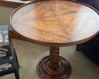 Spindle base wooden table 28" diameter x 27.5"h as found with some scratches as seen in the photo.  $140