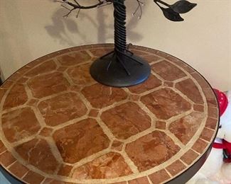 Tile and iron based table is 22" diameter x 25.5"h. $90