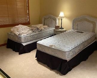 Three piece bedroom set - twin vintage wicker headboards and mattress sets plus a bedside table.  Closeups and dimensions in following photos.  $120 for the set.