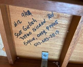 artists signature on the hand carved world map