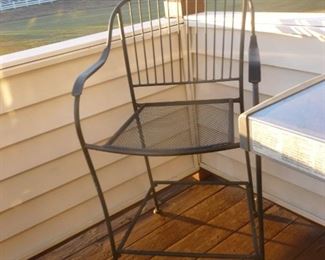 There are 3 of these wrought-iron chairs