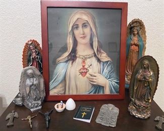 Statuettes, religious small figures, and framed portrait of the Virgin Mary, Jesus Christ, and angels.