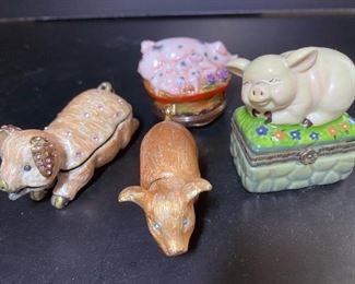 Assorted pig trinket boxes, some with tiny piglets inside