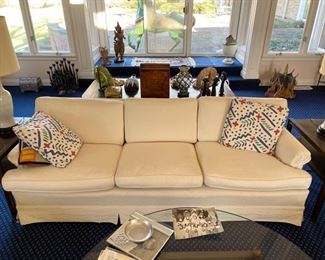 Upholstered white sofa with modern lines. 84" W x 34" D. Needs new seat cushions and new fabric. Priced to move!
