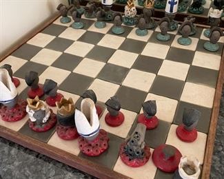 Chess board with clay, hand-made Mexican pieces. Photo 1 of 2. 