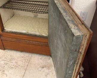 Antique ice box shown with bottom door open