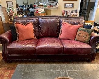 Large comfy leather sofa with hobnail trim. Cushions even have straps to help stay out and not slide