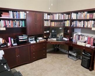 Nice corner office desk and shelves. Assortment of books, electronics, and office supplies