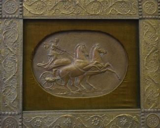 319	Framed Bronze Relief Woman in Chariot	Framed bronze relief of woman in chariot with two horses, velvet mat and embellished bronze frame with floral motif. Discoloration from age. Bottom left corner bronze embellishment missing two studs. Top left corner embellishment missing one stud. Tear in velvet mat on bottom right edge. Sight: 13 1/8" H x 19 1/8" W Frame: 27" H x 32" W