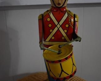 Vintage Wolverine Drum Major No. 27 Tin Wind-Up Toy in Great Working Condition! This is a very nice, clean, Tin Wind Up toy with some scratching but rust free. Drumming action and key wind in great condition. Controlled by "Stop / Start" switch on the left side. The tin toy drummer No. 27 "Drum Major" by Wolverine Supply and Mfg. Co. Uniformed drummer wind-up with drum and sticks on a base. Patented in the 1930’s it stands approximately 13" high. Wolverine was founded in 1903 by Benjamim.F. Bain in Pittsburgh, Pennsylvania. The company originally made and repaired tools and dies. A toy manufacturer contracted with Wolverine to manufacture the tools to build a toy. When the contracting toy company went out of business, Wolverine used the manufactured tools to begin their own line of toys. The Drum Major was designed by Howard N. Barnum of Cleveland, Ohio and was patented on December 17, 1932