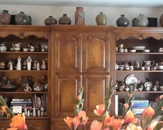 Large wall unit with Copper lustre, Latin American pottery, carved wood items and more.