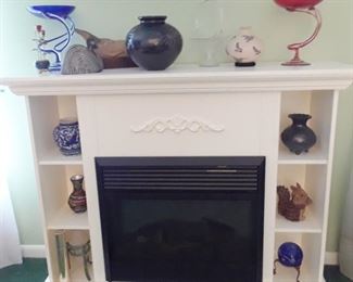 Movable fireplace, pottery and colorful glass.