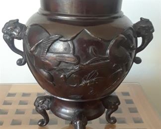 Bronze footed vase with bird and elephant motif.