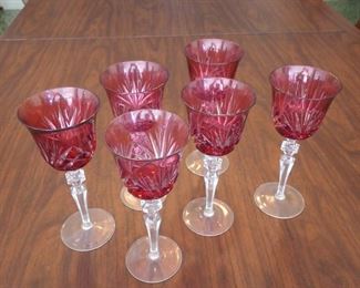 Six of twelve cranberry wine stems shown. Nachman.