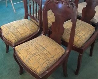 Set of four Edwardian chairs with carved backs. Pop-up seats can be reupholstered easily.