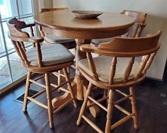 Oak round counter top / bar with four (4) swivel chairs