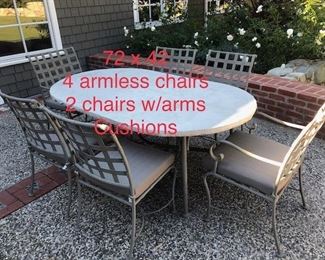 Stone top patio table with six chairs $850. Delivery available for additional fee.