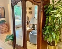 $2000. Elegant mirror faced armoire late 19th C original walnut front and sides. 97"h x 56”w x 19”d. Comes apart for shipping. Delivery and shipping available please enquire. 