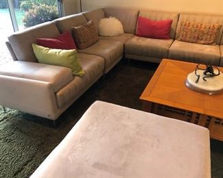 $1600, delivery available. Italian, Natuzzi sectional 108x108x18 and matching large ottoman 36x36x18. Excellent condition. Dark cream suede. No pets, no smoking.