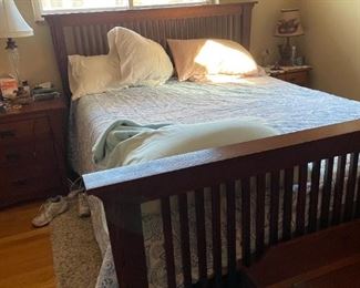 . . . an oak mission-style queen bed and bedding