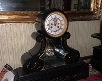 Antique French Clock w/a pair of candle holders.  Made of slate 
Beautiful movement. 