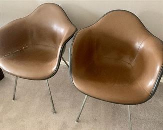 #68- 2 early Eames Herman Miller fiberglass shell chairs covered in leather- $600 for pair