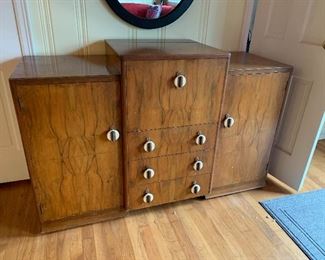 1930's Bauhaus / Art Deco burled walnut Cocktail cabinet bar with bakelite pulls,  drop down front birch interior and mirrored backsplash measures 55" length and 20" depth  and approximately 3' at  greatest height when closed.