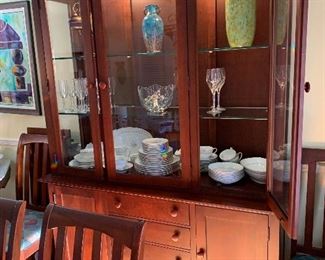 Lighted "Kincaid" mission style china cabinet in cherry  measures 58" across at greatest width , 6' 11" height and 18" depth. Base consists of 4 drawers, 2 doors, 2 half shelves, silver insert Hutch consists of 3 doors, 2 adjustable Glass shelves, curio ends.