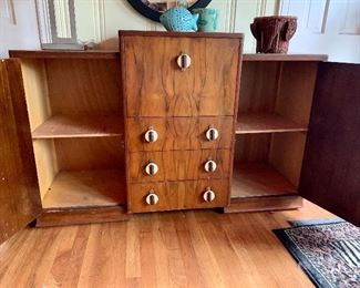 1930's Bauhaus / Art Deco burled walnut Cocktail cabinet bar with bakelite pulls,  drop down front birch interior and mirrored backsplash measures 55" length and 20" depth  and approximately 3' at  greatest height when closed.