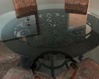 Glorious round glass and cast metal dinning table