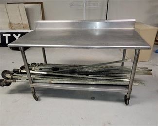 Stainless Steel Table with Backsplash on Casters (CONTENTS OF TABLE NOT INCLUDED)