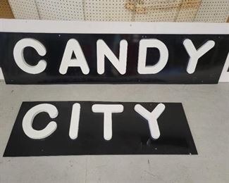Black Background White Lettering Candy City Signs