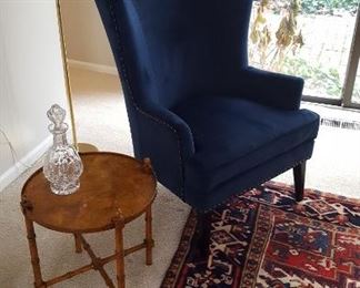 Blue  upholstered wingback chair and bamboo style side table