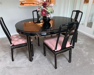 Black Lacquer Oriental Dining Table Set 6 chairs (2 with arms - see other pics), 2 leaves and table pads. Hand painted design, removable cushions. Excellent condition. See all pics. Table Dimensions: 62" wide (no leaves) by 42” deep by 31” tall, 2-leaves- 20 x 42" each, makes table 82" or 102" w if desired.