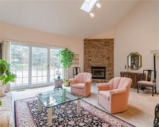 Swivel Arm Chairs, area rug, glass coffee table