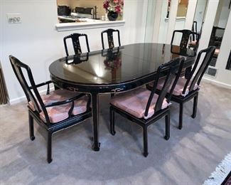 Black Lacquer Oriental Dining Table Set 6 chairs (2 with arms - see other pics), 2 leaves and table pads. Hand painted design, removable cushions. Excellent condition. See all pics. Table Dimensions: 62" wide (no leaves) by 42” deep by 31” tall, 2-leaves- 20 x 42" each, makes table 82" or 102" w if desired.