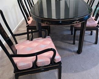 Black Lacquer Oriental Dining Table Set 6 chairs (2 with arms - see other pics), 2 leaves and table pads. Hand painted design, removable cushions. Excellent condition. See all pics. Table Dimensions: 62" wide (no leaves) by 42” deep by 31” tall, 2-leaves- 20 x 42" each, makes table 82" or 102" w if desired.