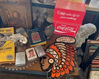 Metal German Shepard dog bookend. Several old lighters, Harley Davidson #1, a southern design, 2 chrome zippos, & a pistol lighter with pearl look grips. Super cool! Giant Native American Chief wearing his headdress stitched  patch & recipes for cooking with Coca Cola. Uh… yum? Maybe!