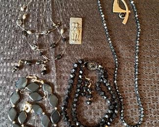 118_____ $42 
Costume Jewelry black tones with Sterling Onyx pin and Angel pin sterl?