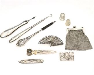 Ten 19th and 20th century Silver pieces.  Includes a button hook, seam ripper, two thimbles, nail file, bookmark, pocket knife, chainmail purse, articulated fan brooch and mask pin.  Each marked or tested, mask pin impressed "800", rest are Sterling.  Approximately 3.71 troy ozs total weight.  Wear and some damage, purse missing links, several monogrammed.  Up to 6" long.  ESTIMATE $50-100
