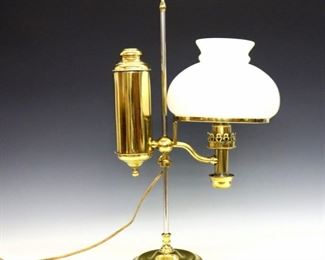 A late 19th century German Brass student lamp.  Single burner on an adjustable stem with Milk Glass shade.  Impressed "C.F.A. Hinrichs, New York" and "C.A. Kleeman" with patent information.  Electrified, minor surface wear and denting to Brass, small chips at Milk Glass rims.  21" high. 
