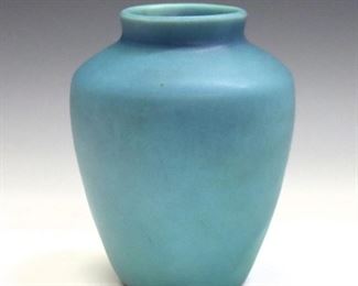 A 20th century Van Briggle art pottery vase.  Simple form with matte Ming Blue glaze.  Incised marks.  Minor wear, some marks to surface.  5 1/4" high.  ESTIMATE $100-200
